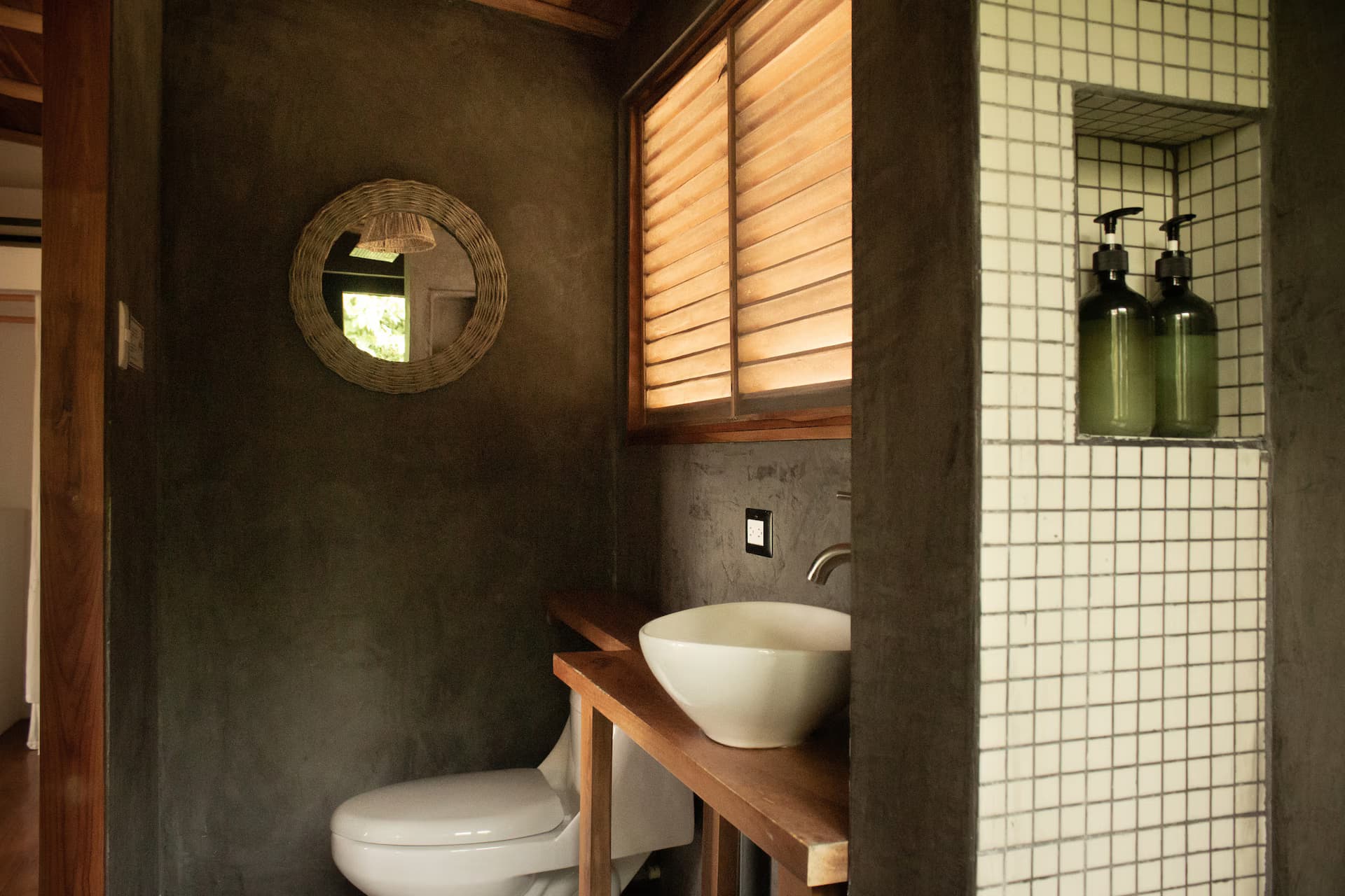 Bedroom corner with round mirror and natural textures