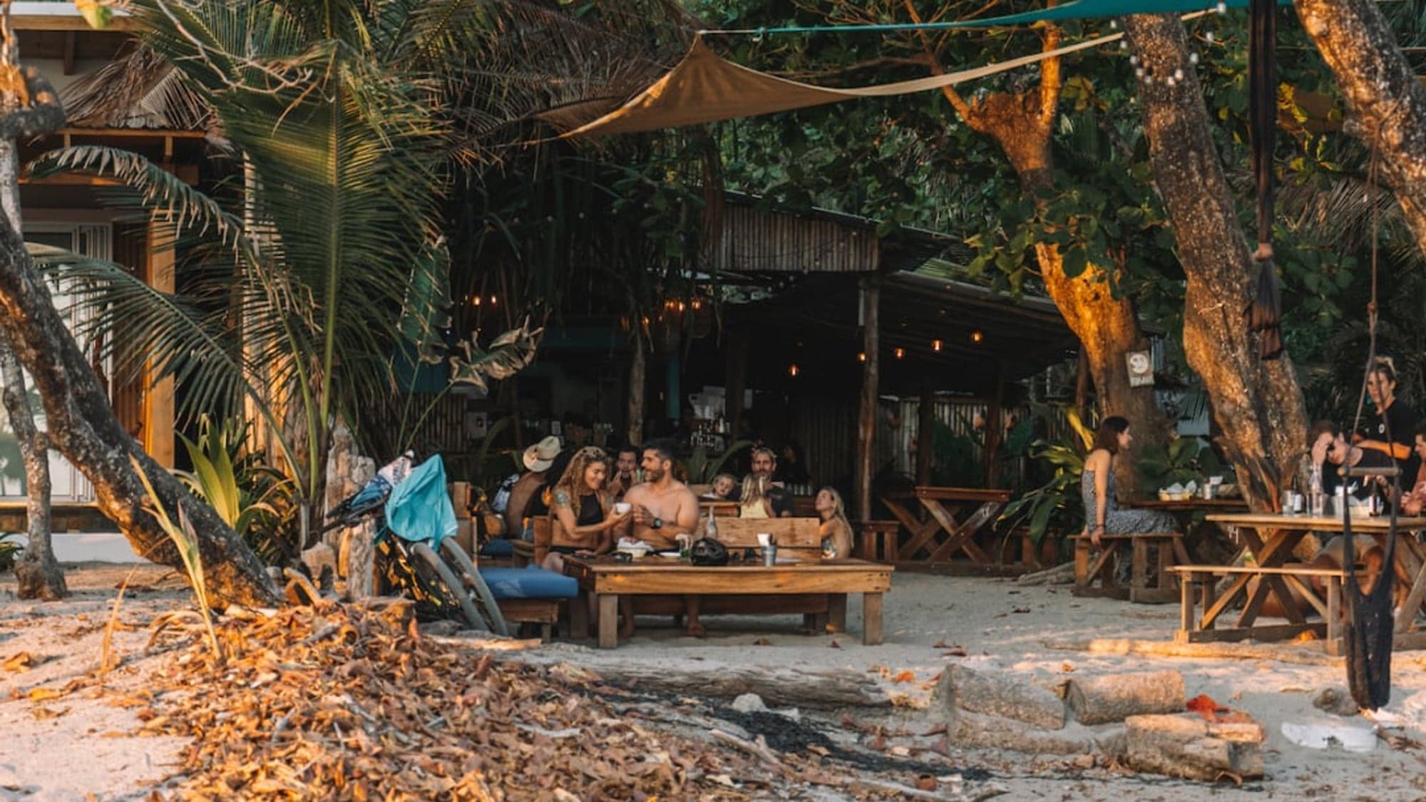 Santa Teresa nightlife — beach bar string lights at sunset