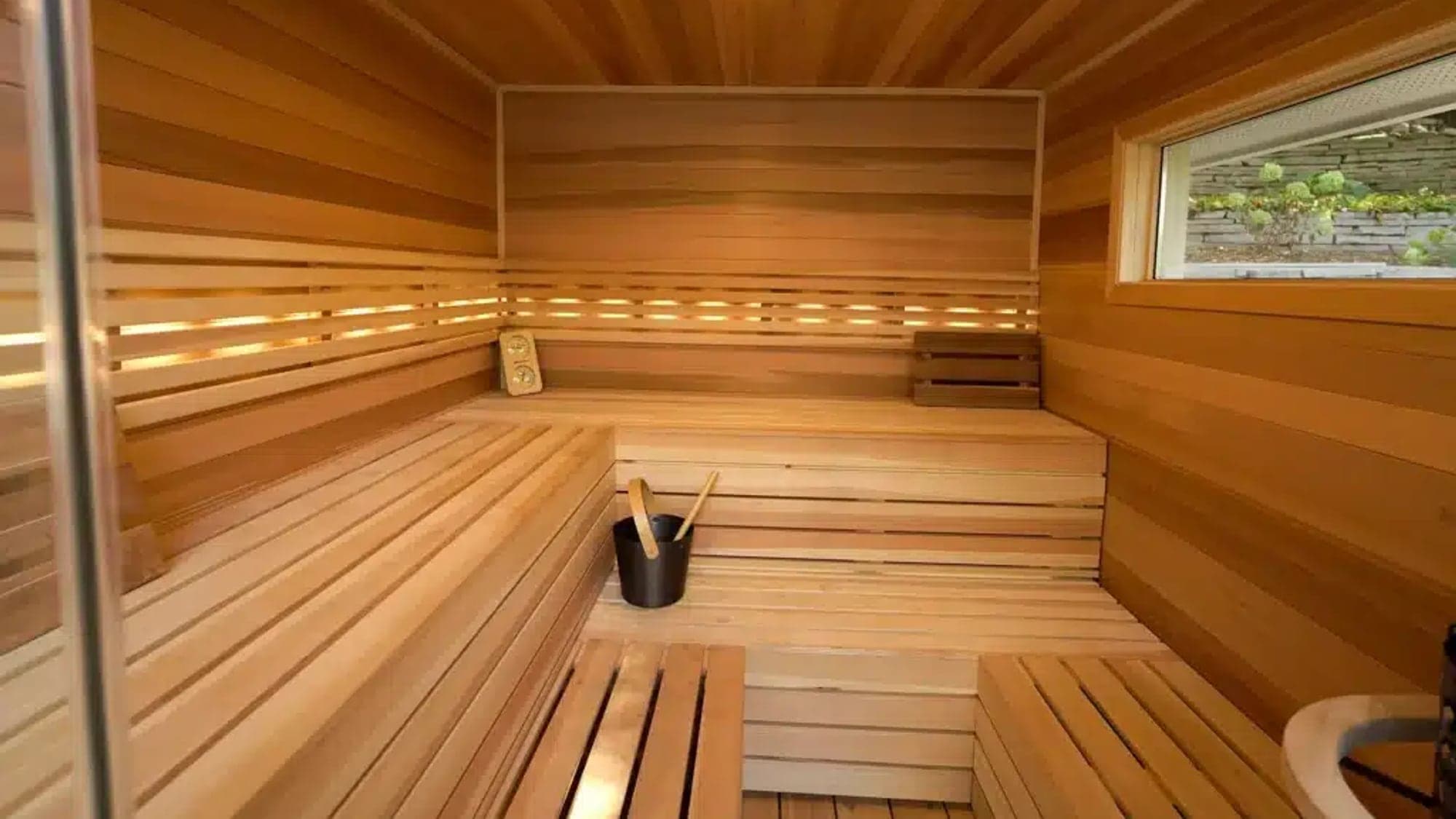 Cedar sauna interior with bucket and ladle